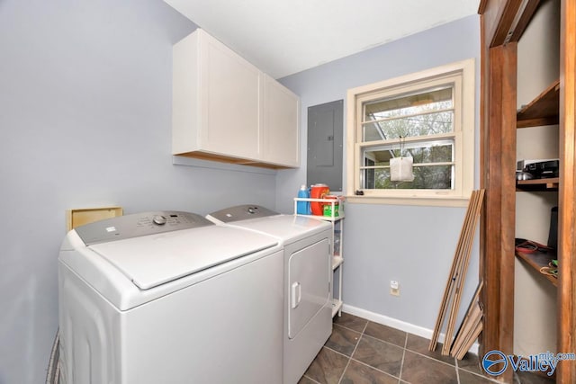 laundry room with electric panel, dark tile patterned floors, washer and dryer, baseboards, and cabinet space