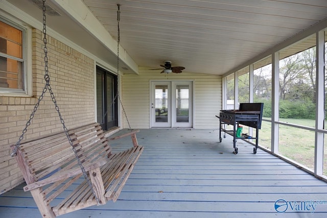 wooden deck with a ceiling fan