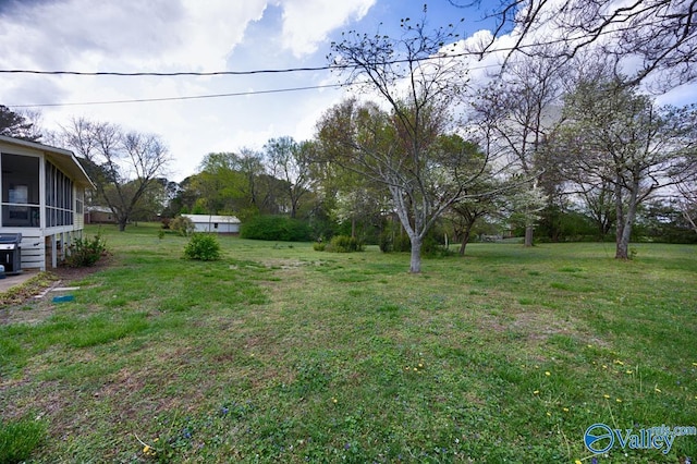 view of yard with a sunroom