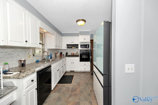 kitchen with white cabinetry, black appliances, under cabinet range hood, decorative backsplash, and a sink