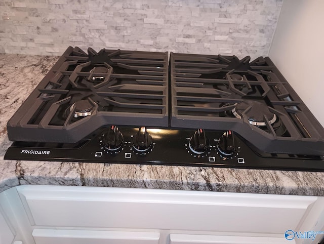 details featuring range and tasteful backsplash