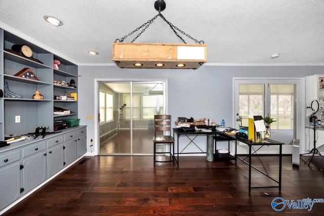 dining space featuring dark wood-type flooring, visible vents, a textured ceiling, and crown molding