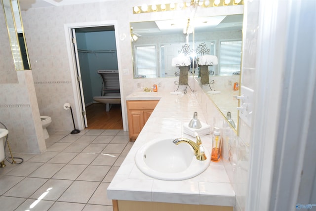 bathroom with tile patterned floors, vanity, toilet, and a chandelier