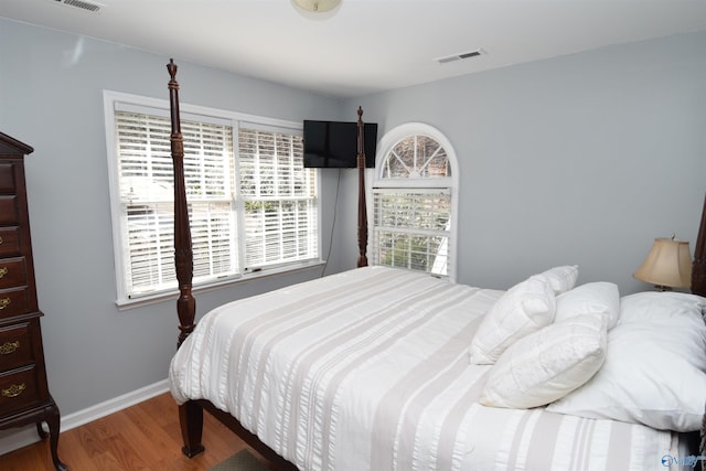 bedroom with hardwood / wood-style flooring