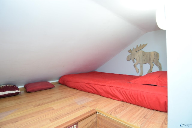 bedroom featuring lofted ceiling and hardwood / wood-style flooring