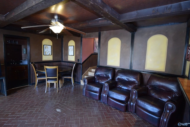 cinema featuring beam ceiling and ceiling fan