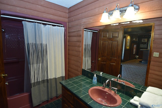 bathroom featuring tile patterned floors, vanity, and wood walls