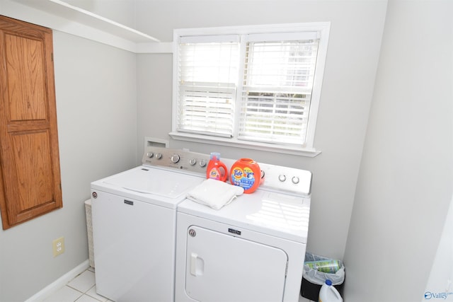 laundry room featuring separate washer and dryer and light tile patterned floors
