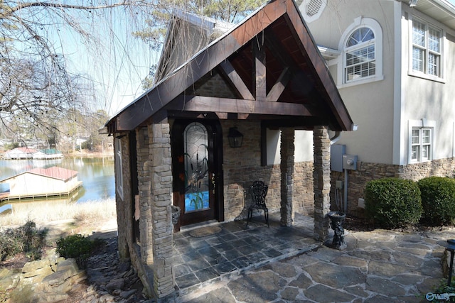 view of exterior entry featuring a water view