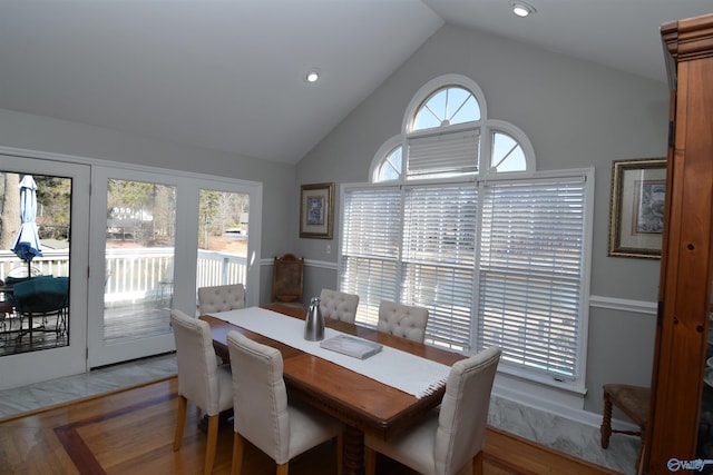 dining room with high vaulted ceiling