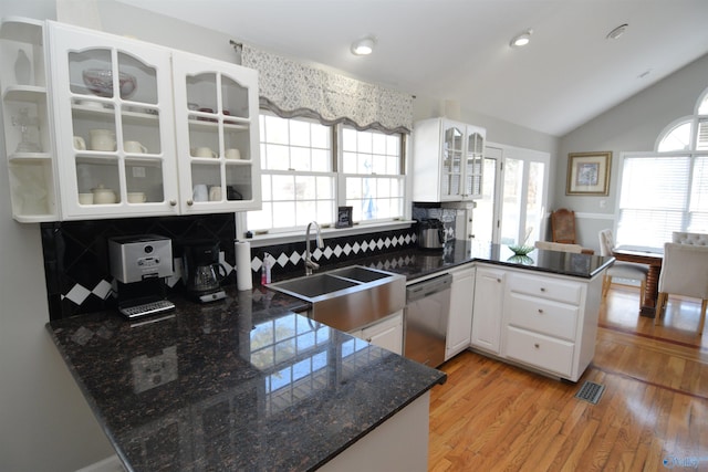 kitchen with sink, white cabinetry, light hardwood / wood-style flooring, dishwasher, and kitchen peninsula