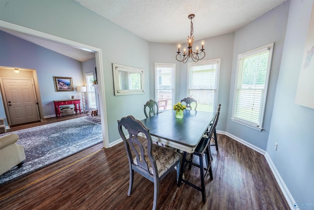 dining space featuring an inviting chandelier, dark wood finished floors, and baseboards