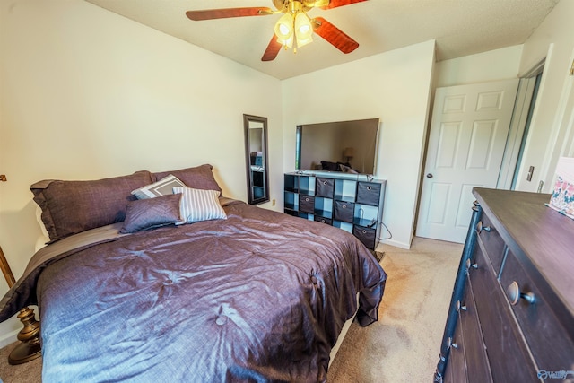 bedroom with light colored carpet, a ceiling fan, and baseboards