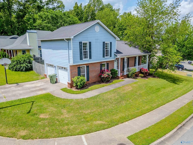 tri-level home with a garage, a front yard, brick siding, concrete driveway, and a porch