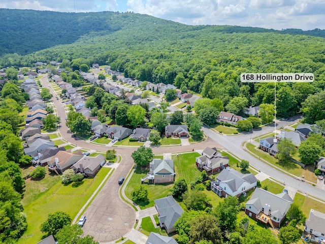 birds eye view of property featuring a residential view and a wooded view