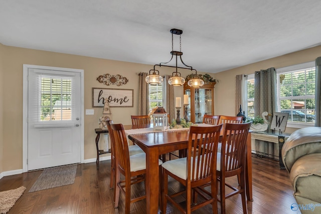 dining area featuring plenty of natural light, dark hardwood / wood-style floors, and a chandelier