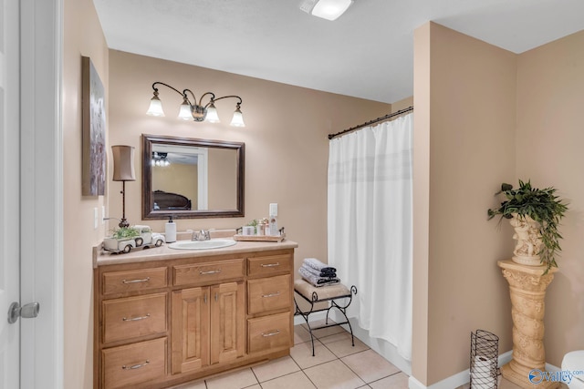 bathroom with tile patterned flooring, vanity, and walk in shower