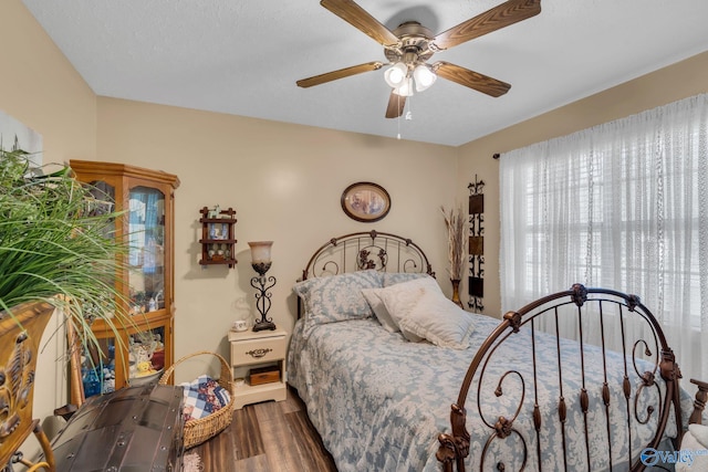 bedroom featuring hardwood / wood-style floors and ceiling fan