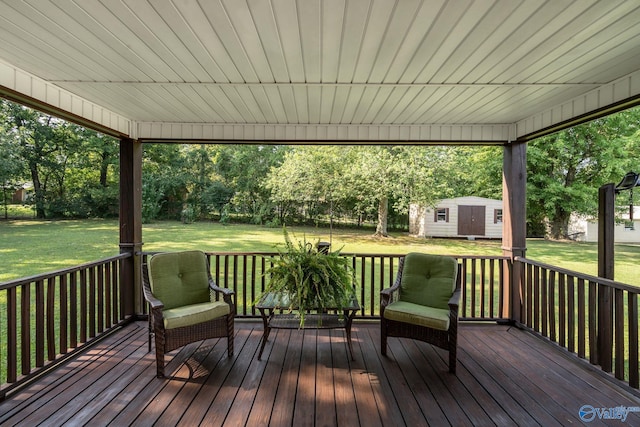 deck featuring a yard and a storage shed