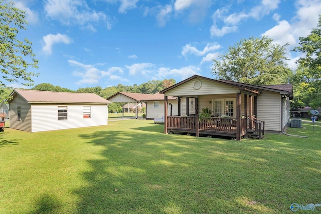 back of house with a deck, central AC unit, and a lawn