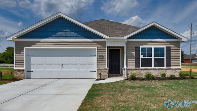 craftsman inspired home with a garage and a front lawn