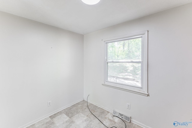 unfurnished room featuring visible vents and baseboards