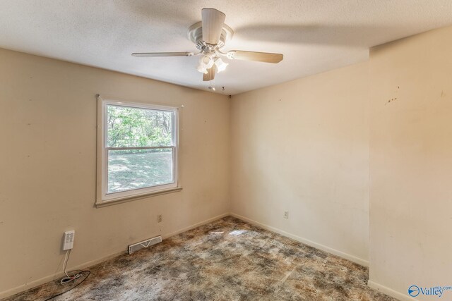 carpeted spare room with baseboards, visible vents, and ceiling fan