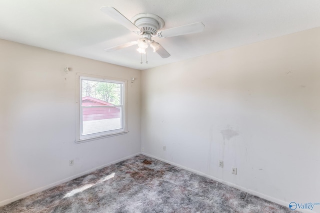 carpeted empty room with ceiling fan and baseboards