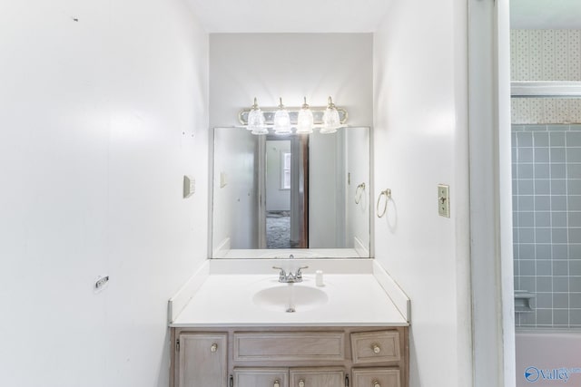 full bathroom with a tub to relax in and vanity