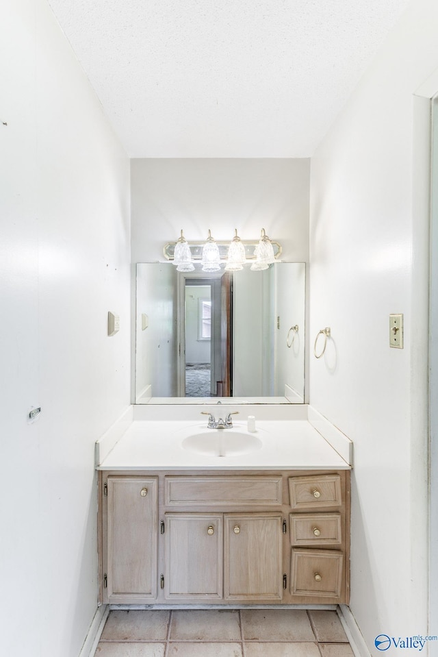 bathroom featuring baseboards, vanity, and tile patterned floors