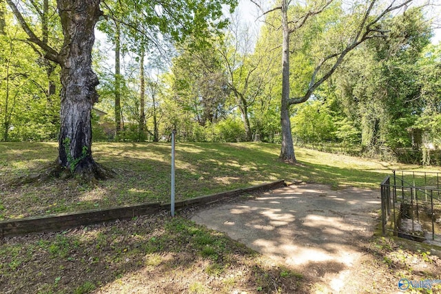 view of home's community with a yard and fence