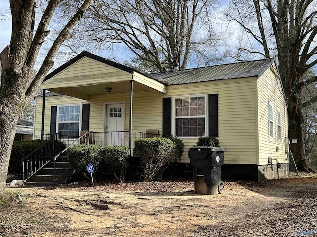 view of front facade with covered porch and metal roof