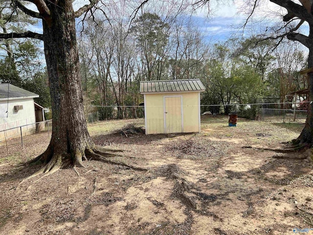 view of yard featuring a storage unit, an outdoor structure, and a fenced backyard