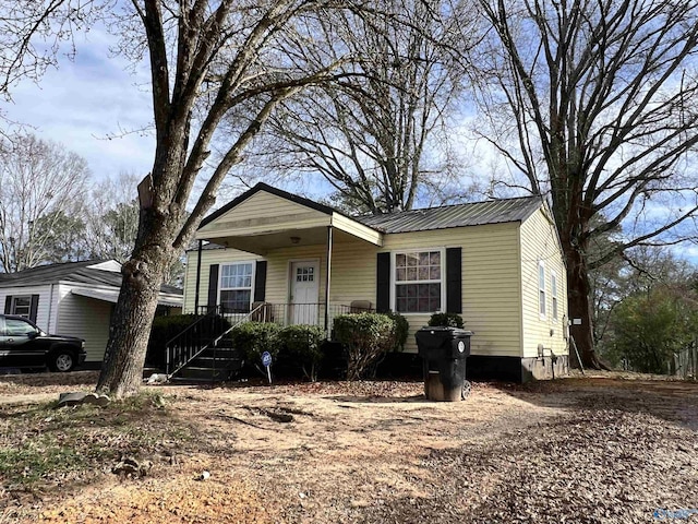 view of front of home with covered porch and metal roof