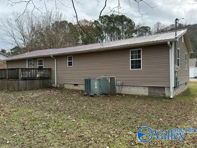 back of house featuring central AC unit and a deck