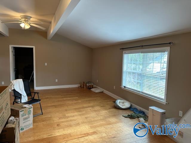 interior space featuring beam ceiling, ceiling fan, and light hardwood / wood-style floors