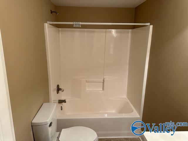 bathroom with shower / bathtub combination and toilet