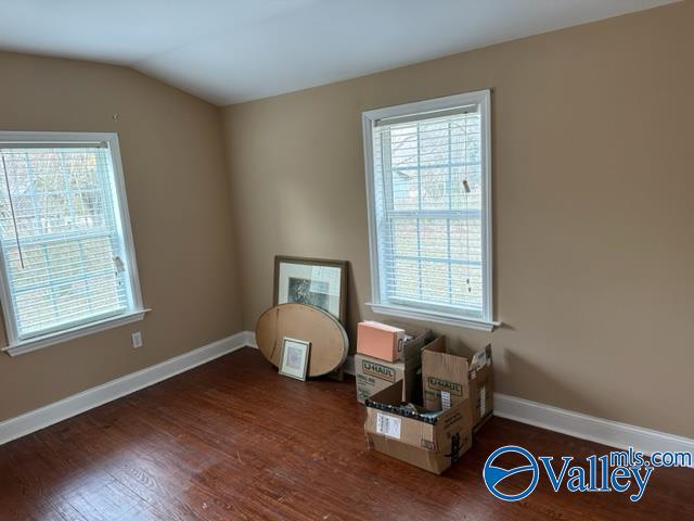 sitting room with dark hardwood / wood-style floors and lofted ceiling