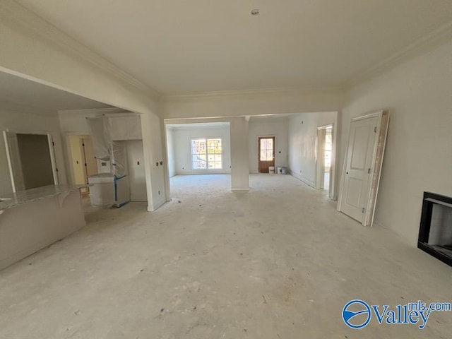 unfurnished living room with crown molding