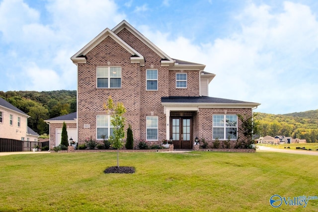 view of front facade with french doors and a front lawn