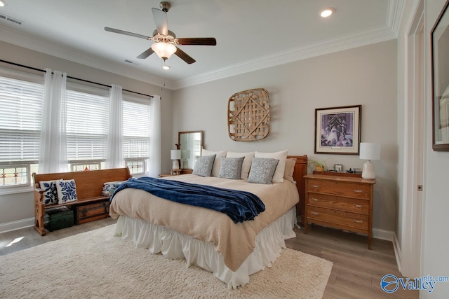 bedroom with multiple windows, ceiling fan, hardwood / wood-style flooring, and crown molding