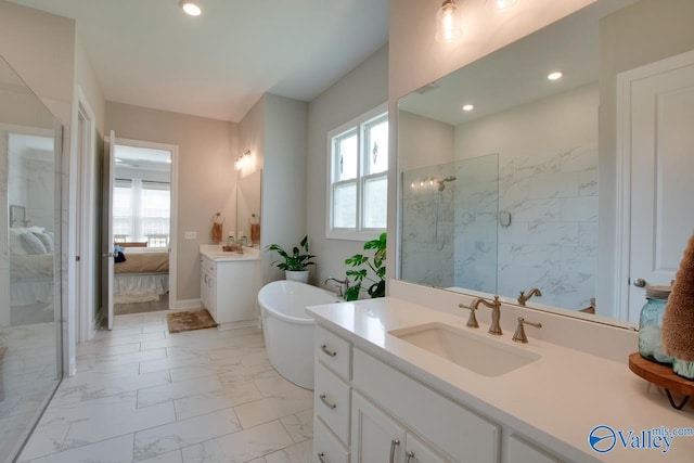 bathroom with independent shower and bath, vanity, and a wealth of natural light