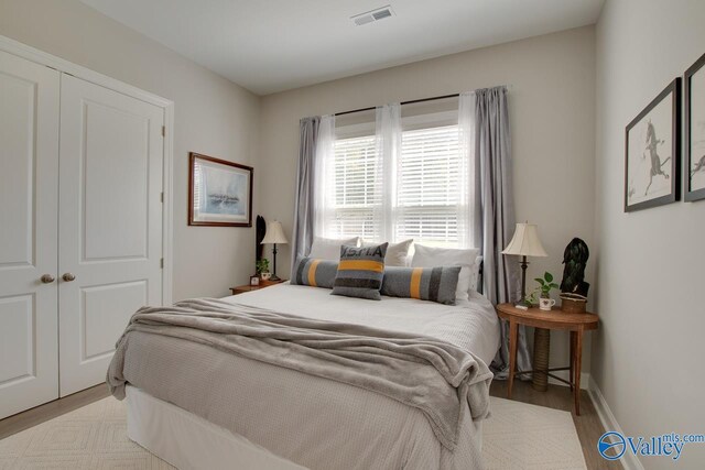 bedroom featuring light hardwood / wood-style floors and a closet