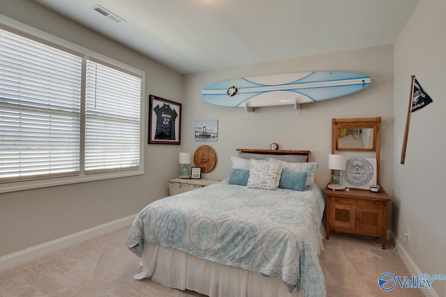 carpeted bedroom featuring multiple windows