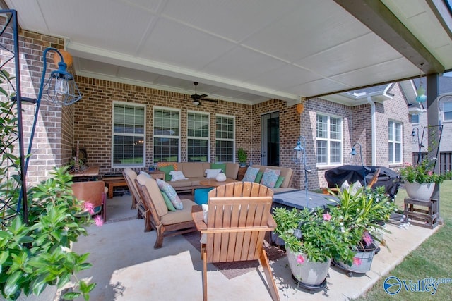 view of patio featuring area for grilling, ceiling fan, a hot tub, and outdoor lounge area