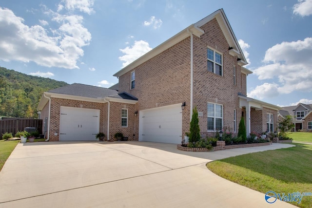 view of side of property with a lawn and a garage