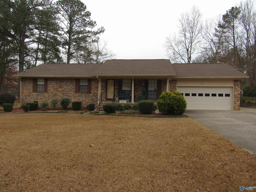 single story home with a garage and a front yard