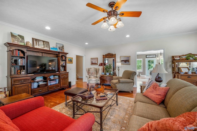 living area with a ceiling fan, wood finished floors, baseboards, recessed lighting, and ornamental molding