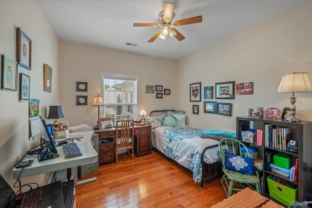 bedroom with visible vents, wood-type flooring, and ceiling fan