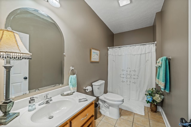 full bathroom featuring tile patterned flooring, baseboards, toilet, vanity, and a textured ceiling